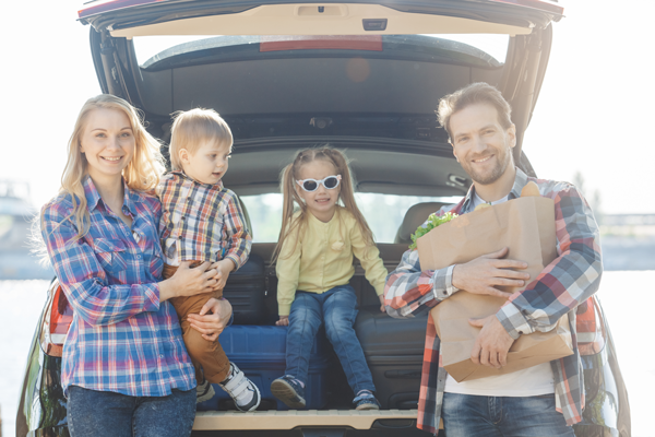 Family packs their van with food allergy friendly groceries for vacation
